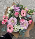 Pretty in Pink bouquet with chrysanthemums, gerberas, roses and eucalyptus wrapped in kraft paper